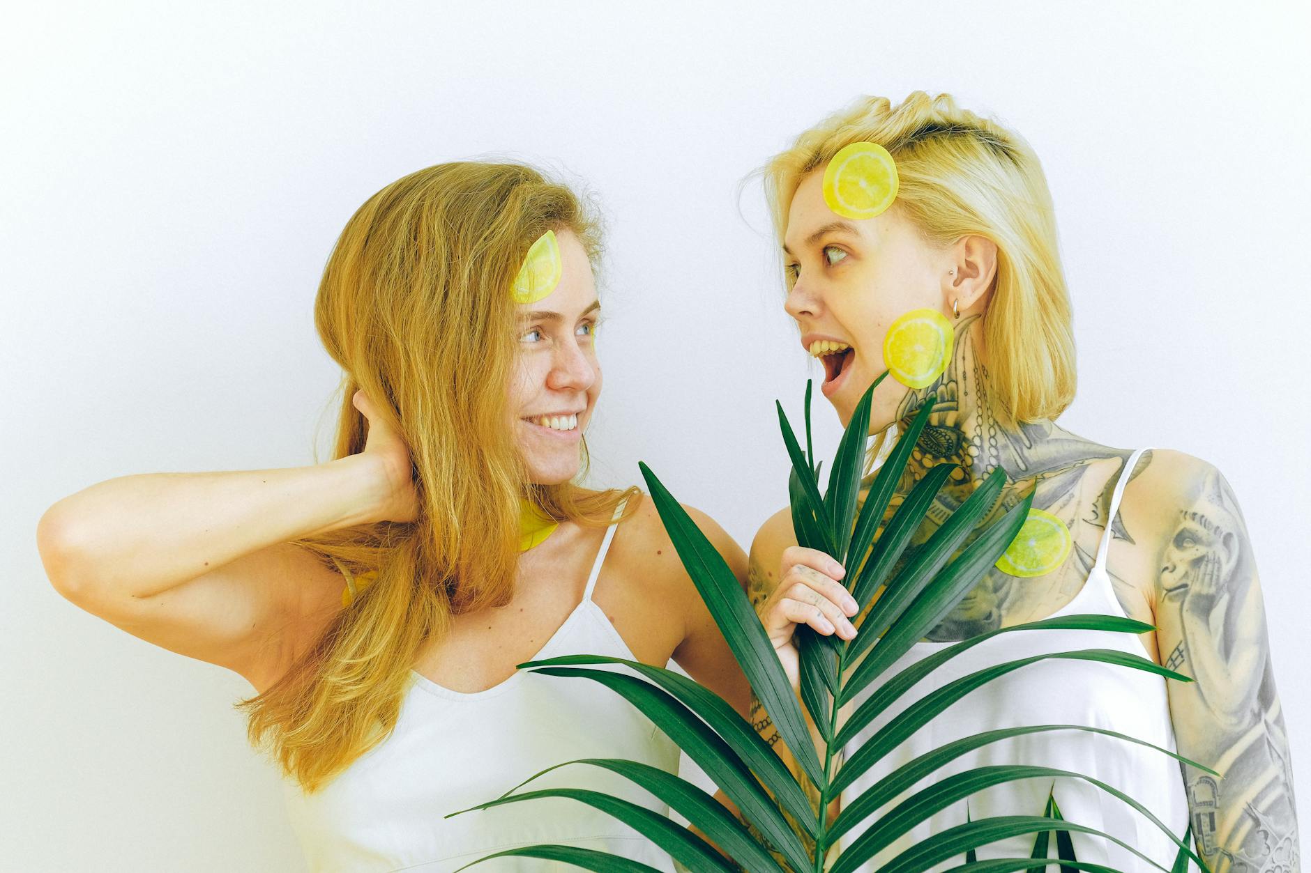 Two women smiling joyfully indoors, expressing confidence and happiness