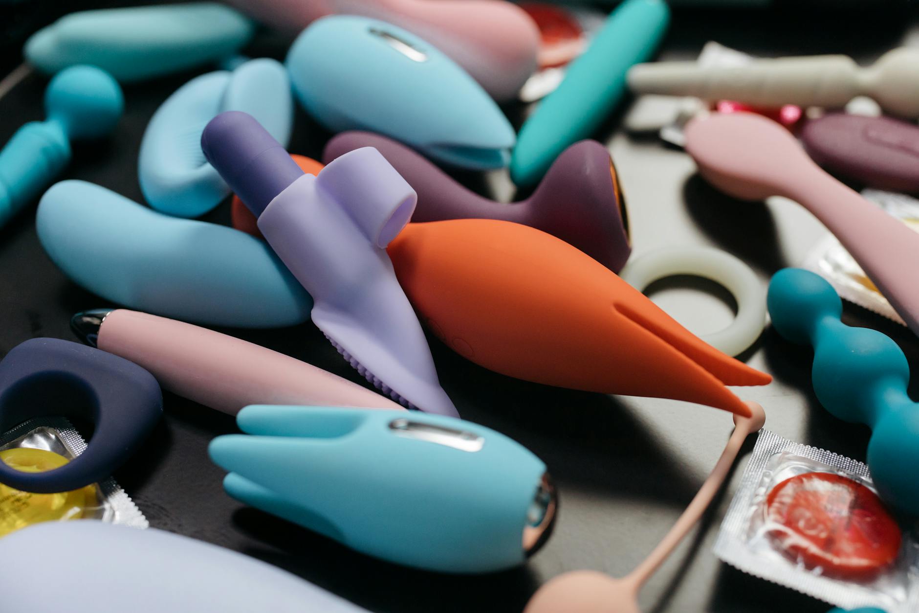 Woman holding vibrators in a contemplative moment during intimacy recovery